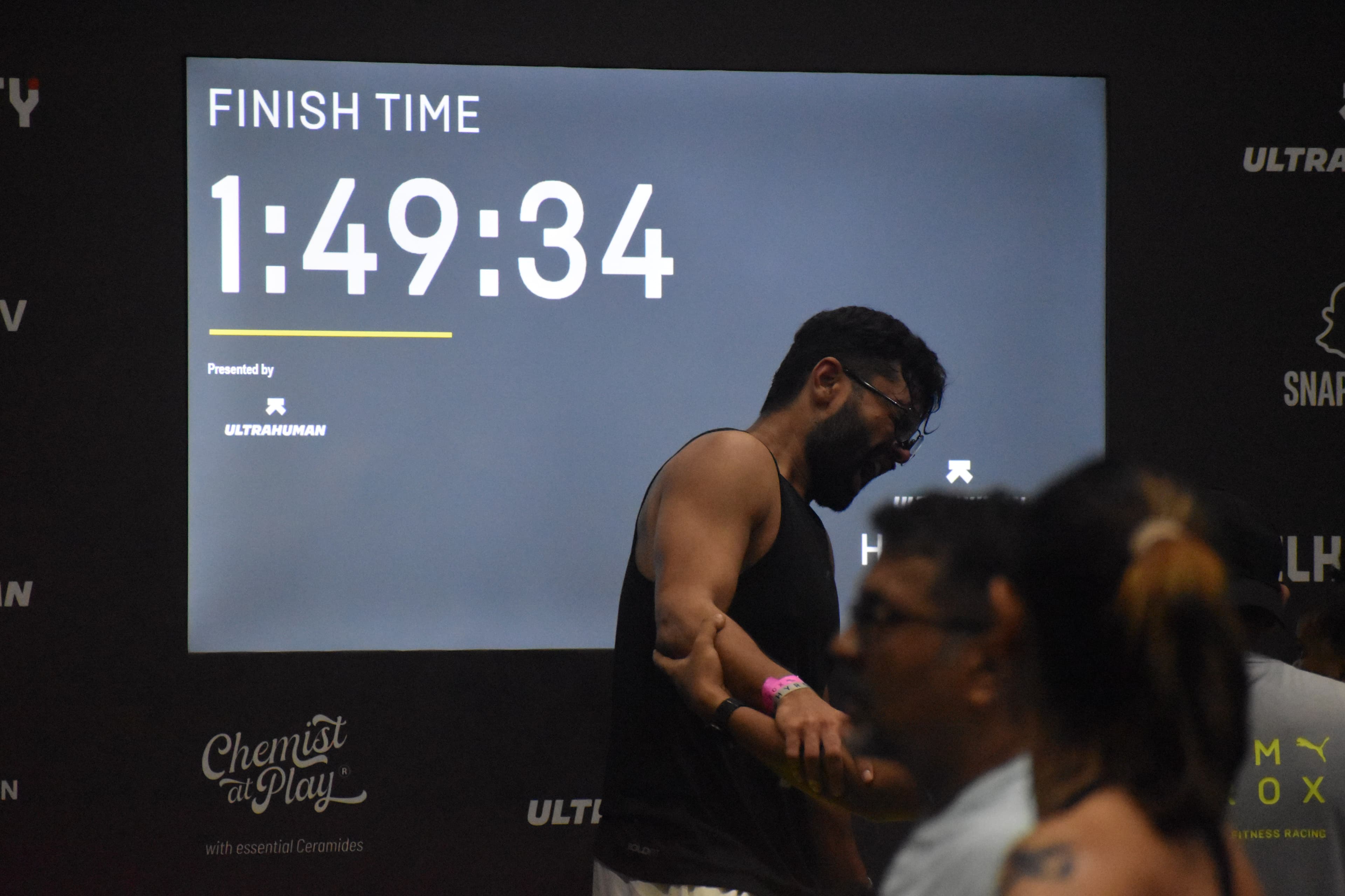 Naman screaming at the HYROX Bangalore 2026 finish — 1:49:34 on the board behind him